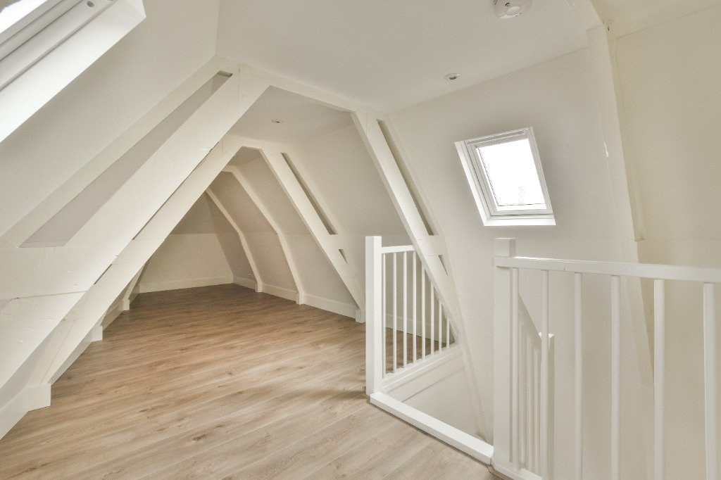 White painted A-frame timber beam stair landing